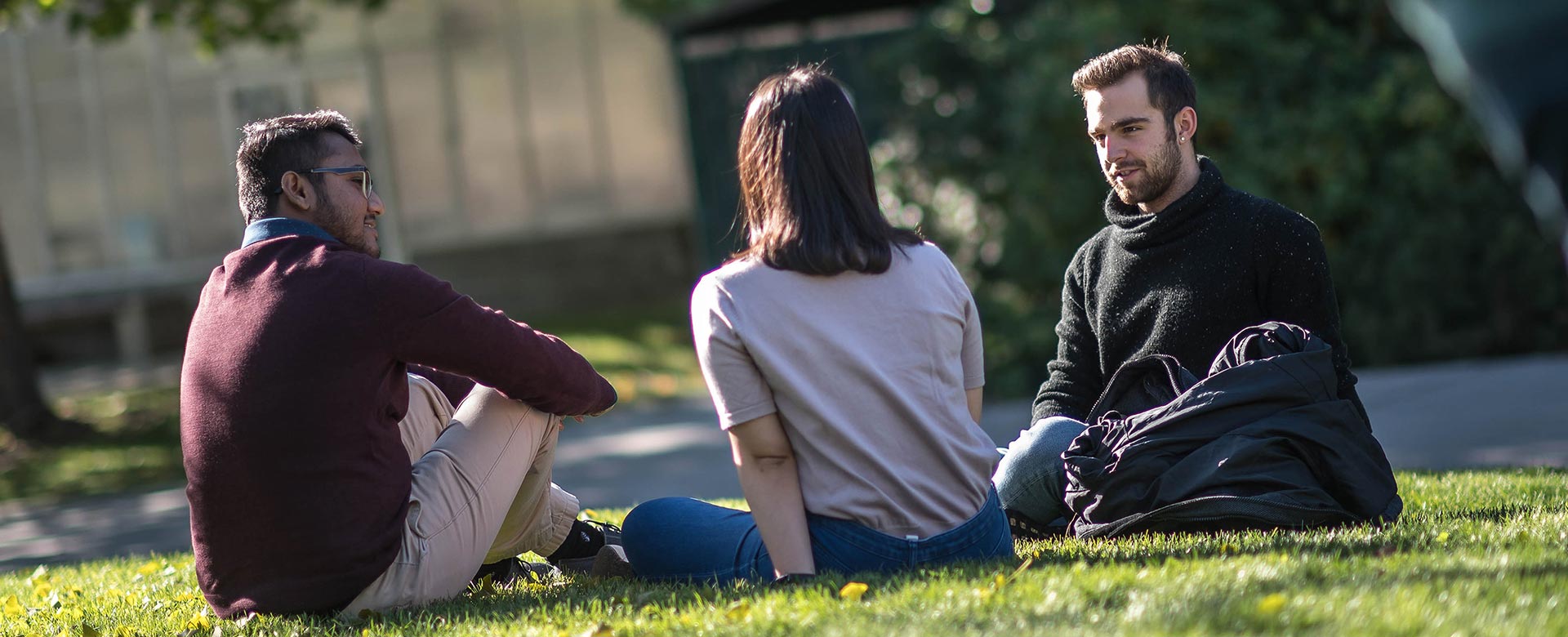 Students sitting on the grass at UBCO campus